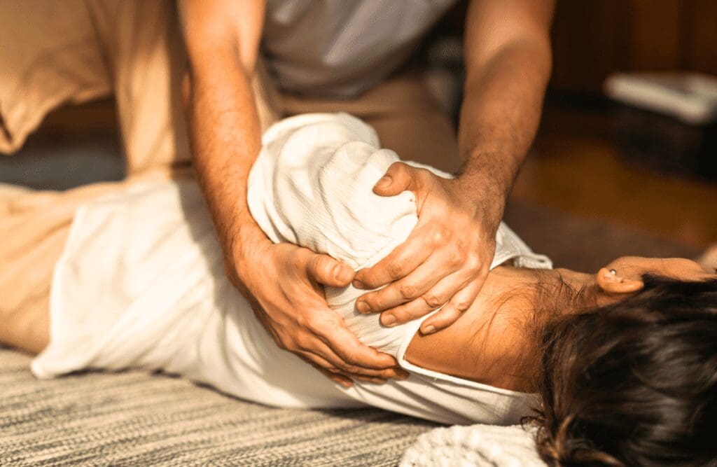 Woman with frozen shoulder receives a stretch and acupressure Massage Chrmside. Thai Massage. Brisbane Livewell Clinic