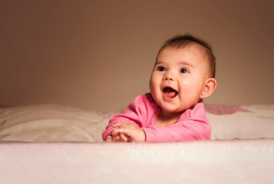 Smiling Baby Lying on Bed in Room. Fertility Naturopath Brisbane. Faltering Growth. Brisbane Livewell Clinic