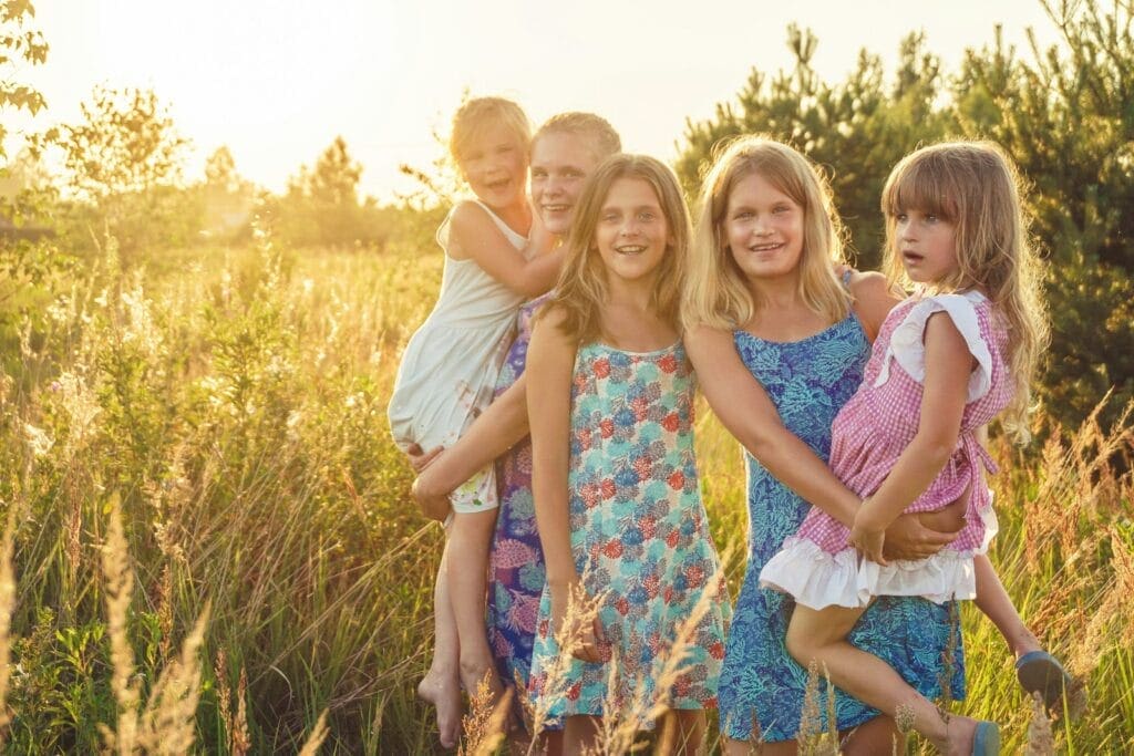 Happy family standing in long grass. Brisbane Wellness Centre. How to Get an Allergy Test in Australia. Brisbane Livewell Clinic