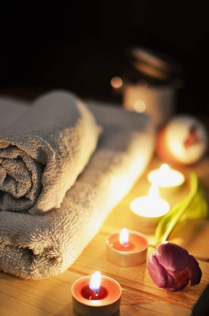 Four Lit Tealights and Massage Towels. Massage. Brisbane Livewell Clinic