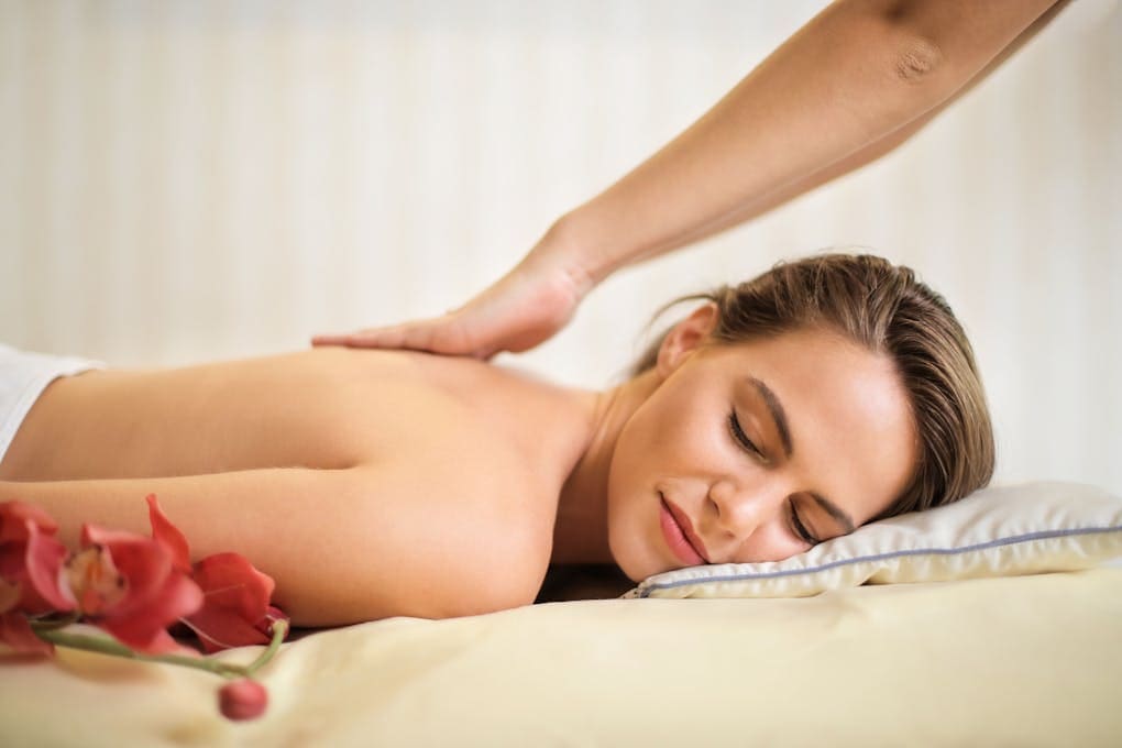 Woman Lying on Bed Getting Massage. Myofascial Release Therapy. Massage Brisbane. Full body massage Brisbane
