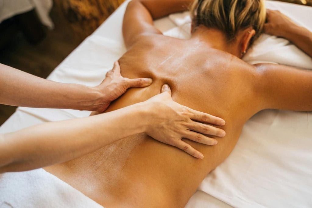 Masseur massaging woman's back. Massage. Brisbane Livewell Clinic