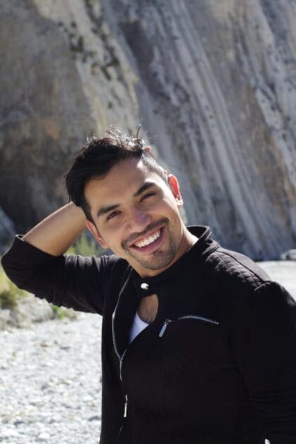 Smiling man in black jacket wearing red headphones representing ceasing drinking excessively.