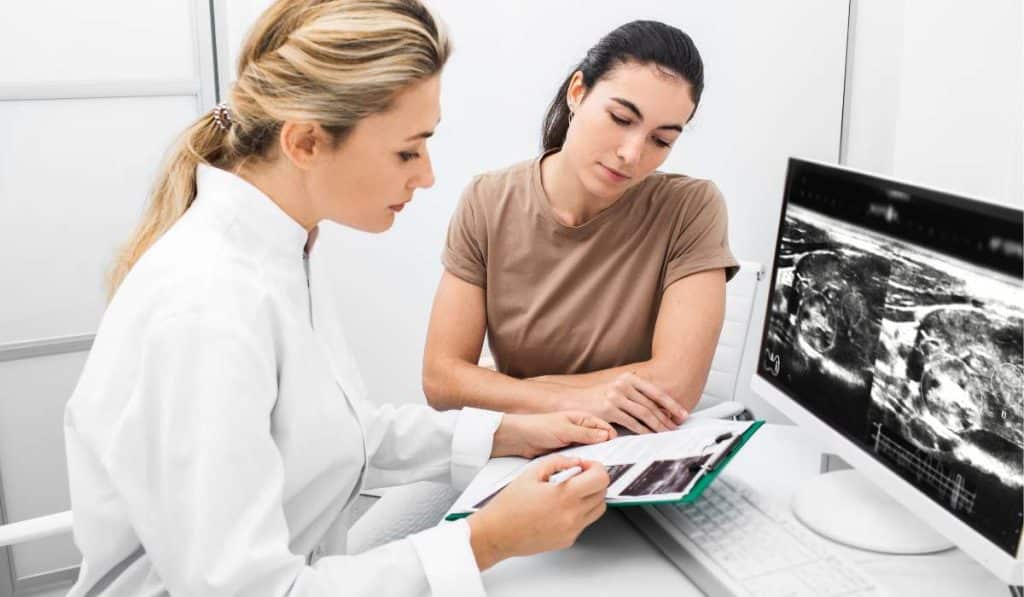 Naturopath checking report of Hyperthyroidism. Brisbane Livewell Clinic