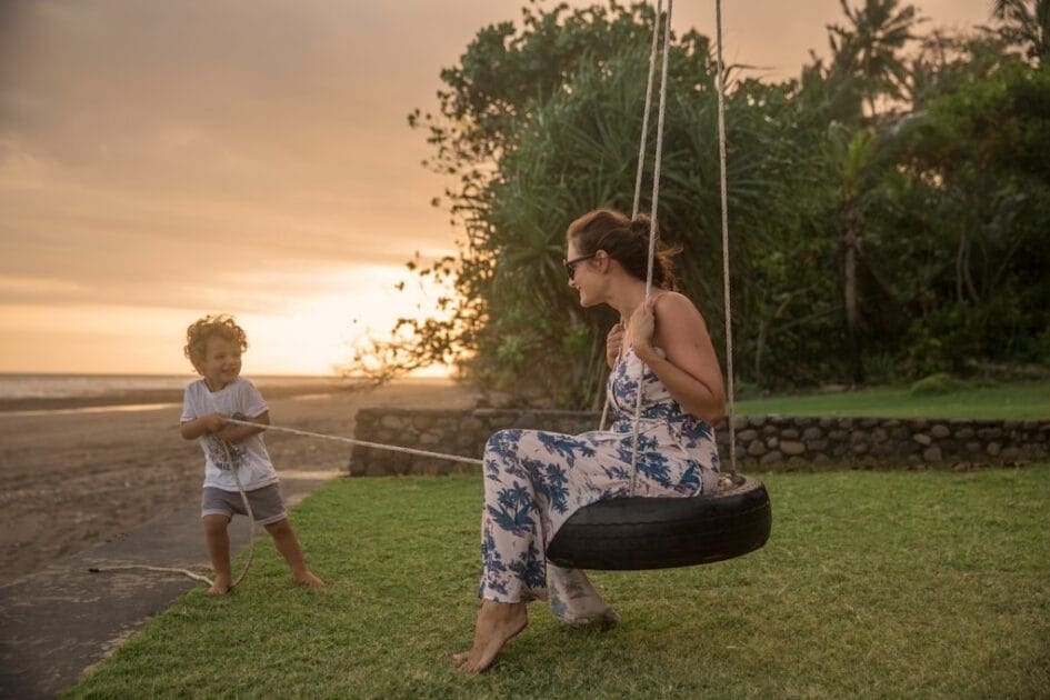 Woman on tire swing pulled by boy. Best Naturopaths Near Me