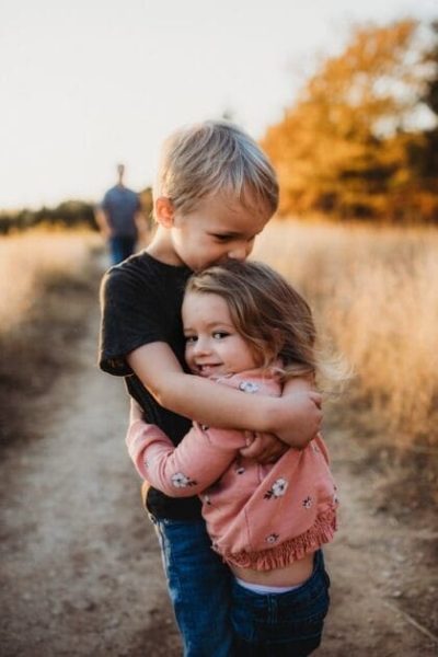Boy in black t-shirt hugging girl in red and white polka dot dress. DNA Health Testing at Brisbane Livewell Clinic.