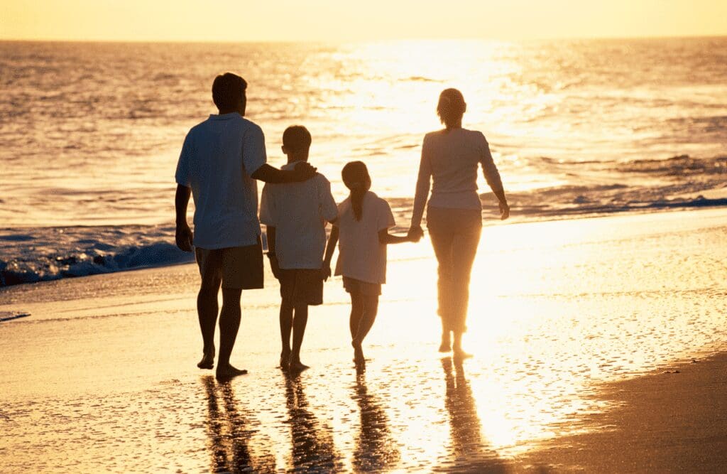 Family walking on the beach. Nutritionist