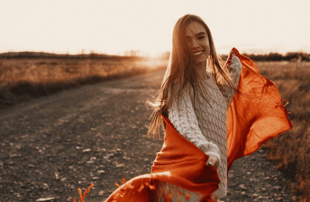 Happy woman having fun outdoors. Hypnotherapy to Reduce Anxiety. Brisbane Livewell Clinic