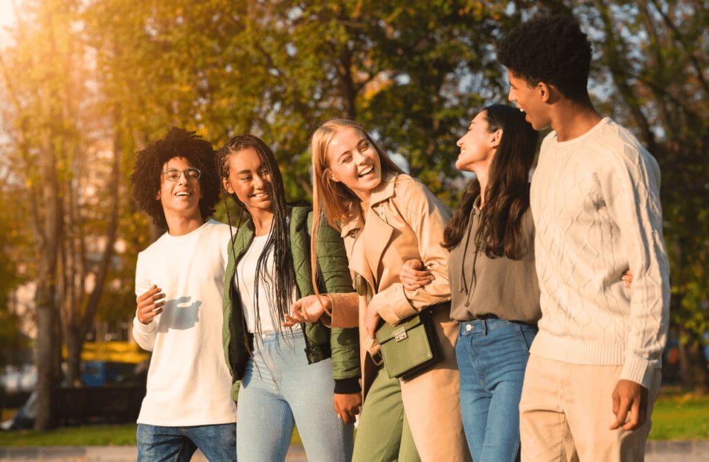 Group of teenagers laughing while walking. Wellbeing. Children's Naturopath. Stress and anxiety in teenagers. Quit Smoking Hypnotherapy. Osteopath for Hip Pain and Pelvic Discomfort. Brisbane Livewell Clinic