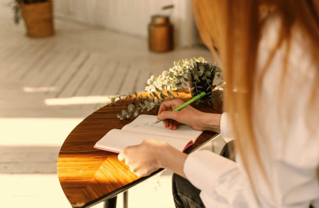 Woman writing on a paper. Naturopath Sunshine Coast. Brisbane Livewell Clinic