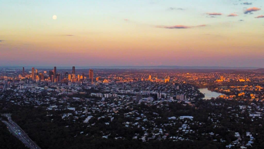 City skyline under orange sky during sunset. Brisbane City. Locations we Service. Brisbane Livewell Clinic