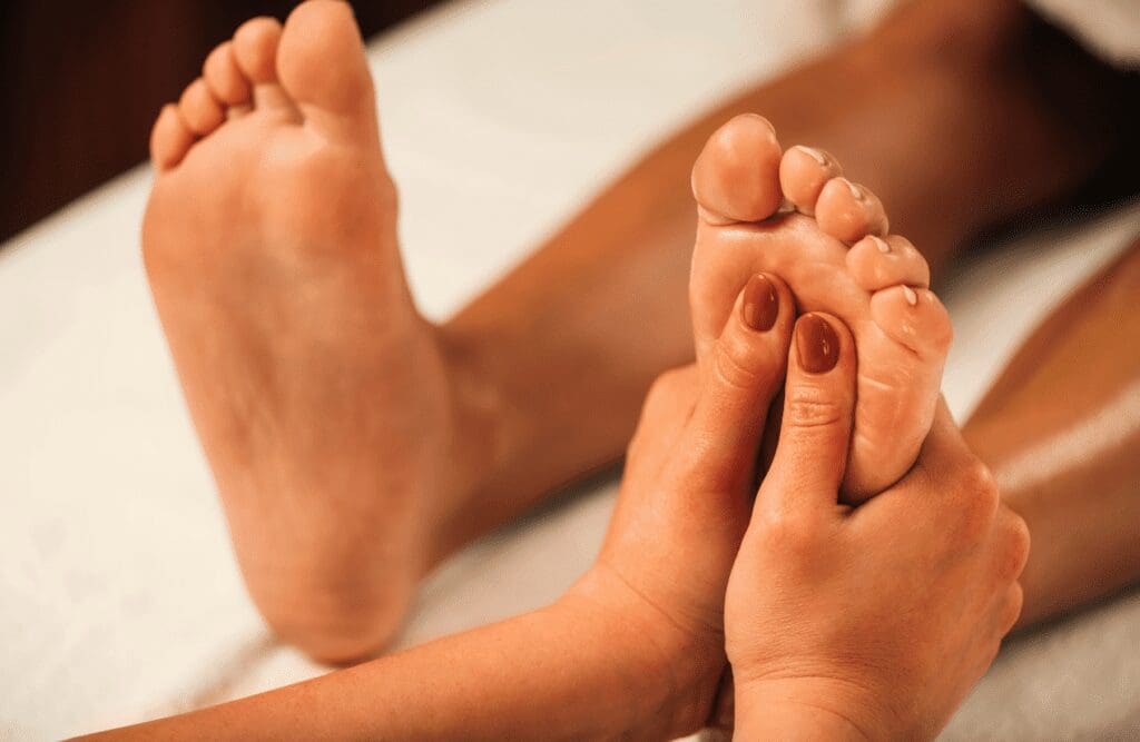 Practitioner applying to client's foot during Massage Chermside West. Reflexology. Brisbane Livewell Clinic
