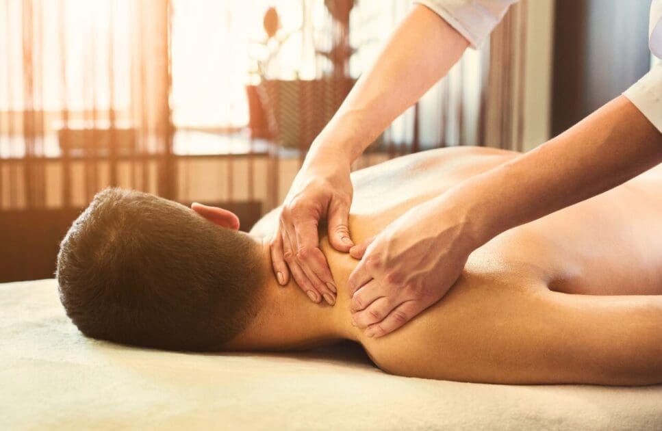 Massage therapist massaging male shoulders. Myofascial Release Therapy Massage Near Me. Trigger Point Therapy Brisbane. Brisbane Livewell Clinic