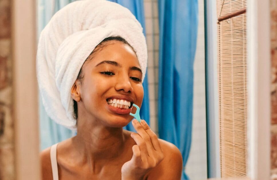 Woman cleaning her teeth with floss. Nutrition Deficiency. Brisbane Livewell Clinic