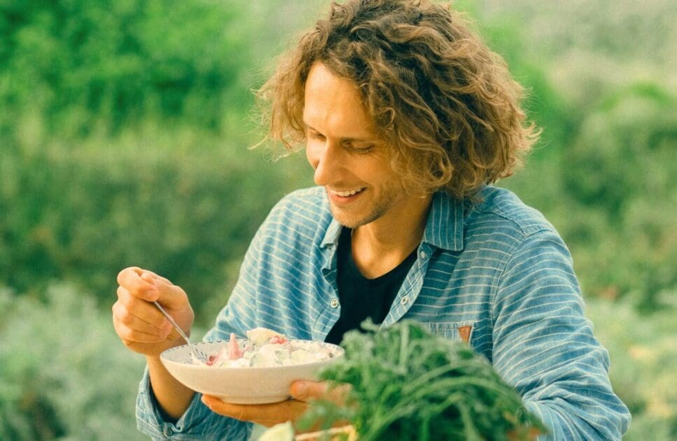 Man eating healthy salad outdoors. MTHFR Gene Test. Brisbane Livewell Clinic