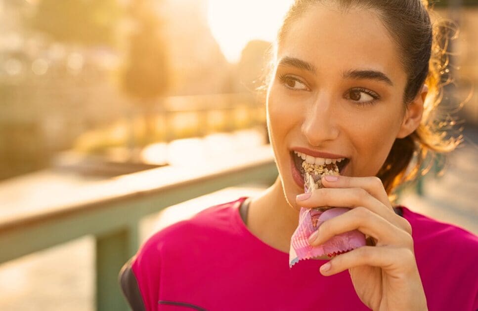 Woman eating protein bar. Weight Loss for Summer. Mood & Food. Brisbane Livewell Clinic