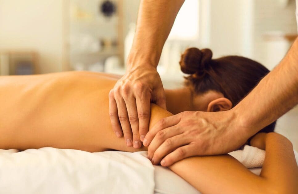 Masseur gives woman a relaxing back and shoulder massage. Massage Therapy. Brisbane Livewell Clinic