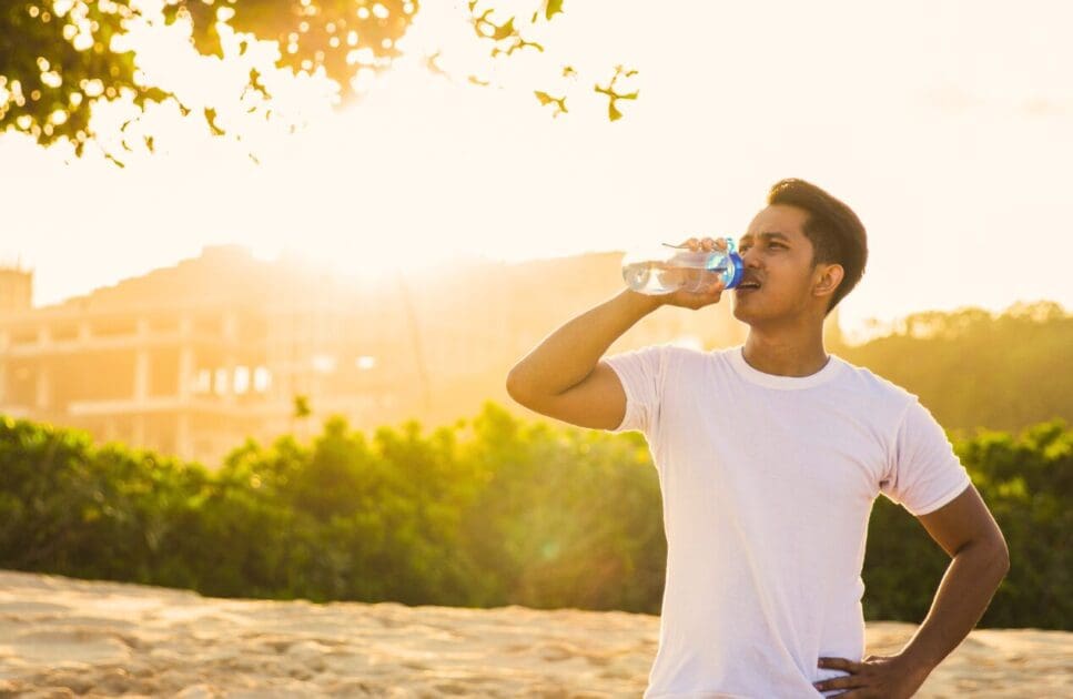 Man drinking water outdoors. Thyroid Health. Full Genetic Testing Australia. Is Brisbane Livewell Clinic