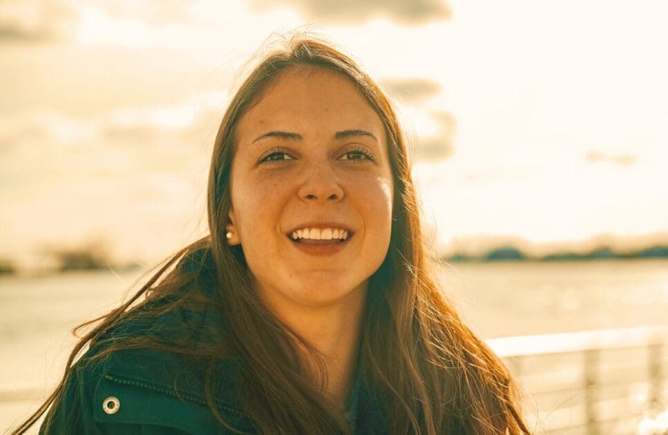 Smiling woman enjoying sunset. Hyperthyroidism. Perimenopause. Brisbane Livewell Clinic