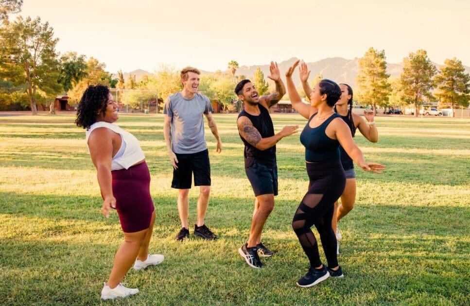 Group of adults having fun in the park. Naturopath Noosa. Health screening. Age. Professional Bowen Therapy. Osteopath for Hip Pain. Brisbane Livewell Clinic