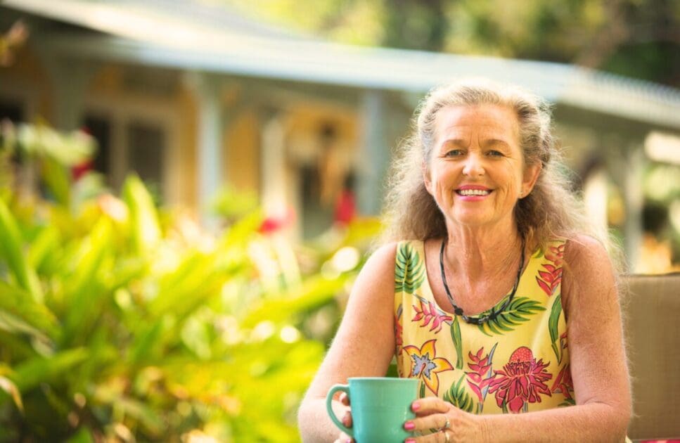 Woman sitting outdoors while drinking coffee. Gut Microbiome Testing Australia. At home hormone test. Brisbane Livewell Clinic