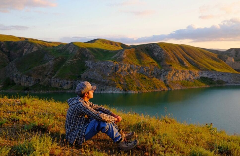 Man sitting on top of a hill. Natural Therapies Brisbane. What is Clinical Hypnotherapy. Professional Bowen Therapy. Emotionally Overwhelmed Holistic Counselling. Brisbane Livewell Clinic