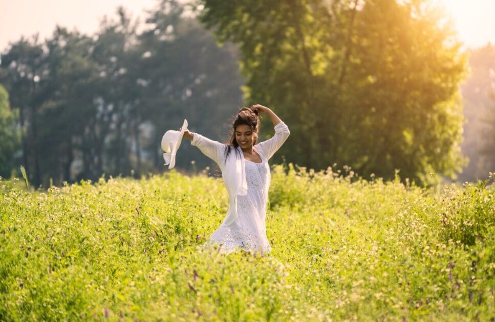 Happy woman enjoying nature. How to get Hormone Levels Checked. Osteopathy for Hip Pain and Pelvic Imbalance. Brisbane Livewell Clinic