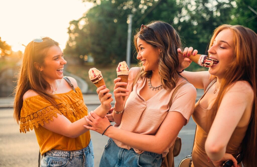 Three female friends eating ice cream. Food Allergy Testing Near Me. How to Get an Allergy Test in Australia. Brisbane Livewell Clinic
