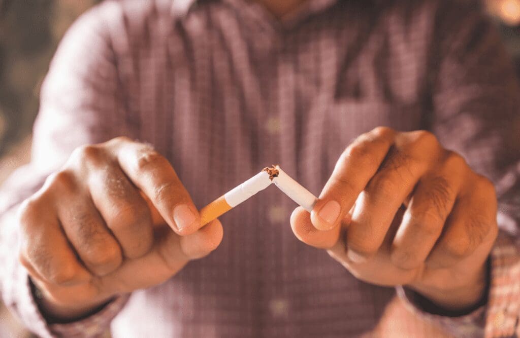 Man breaking cigarette. Hypnotherapy to quit smoking. Brisbane Livewell Clinic