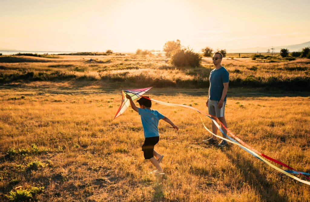 Father and son playing with kite outdoors. Clinical Hypnotherapy Bulimba. Brisbane Livewell Clinic. Naturopaths Brisbane. Hypnotherapy for Smoking
