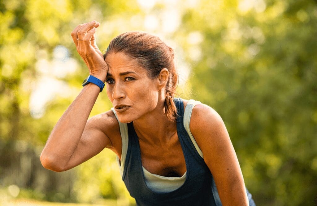 Woman around 40 wiping her sweat after workout. Toxicity. Brisbane Livewell Clinic