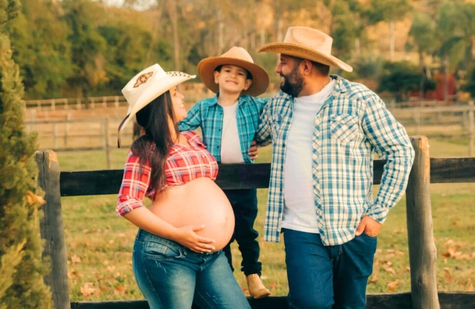 Pregnant woman and her family standing in a field. Pregnancy Massage Near Me. What is Pregnancy Massage. Brisbane Livewell Clinic