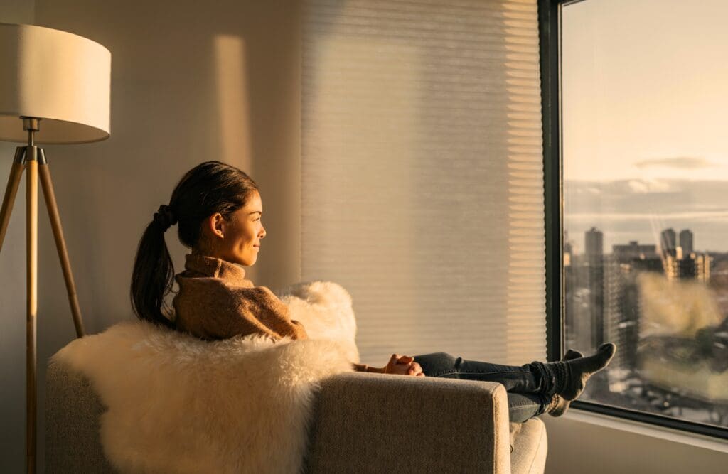 Woman relaxing at home looking out the window. Clinical Hypnotherapy Morningside. What is Bowen Treatment. Hypnotherapy for Alcohol Addiction. Brisbane Livewell Clinic