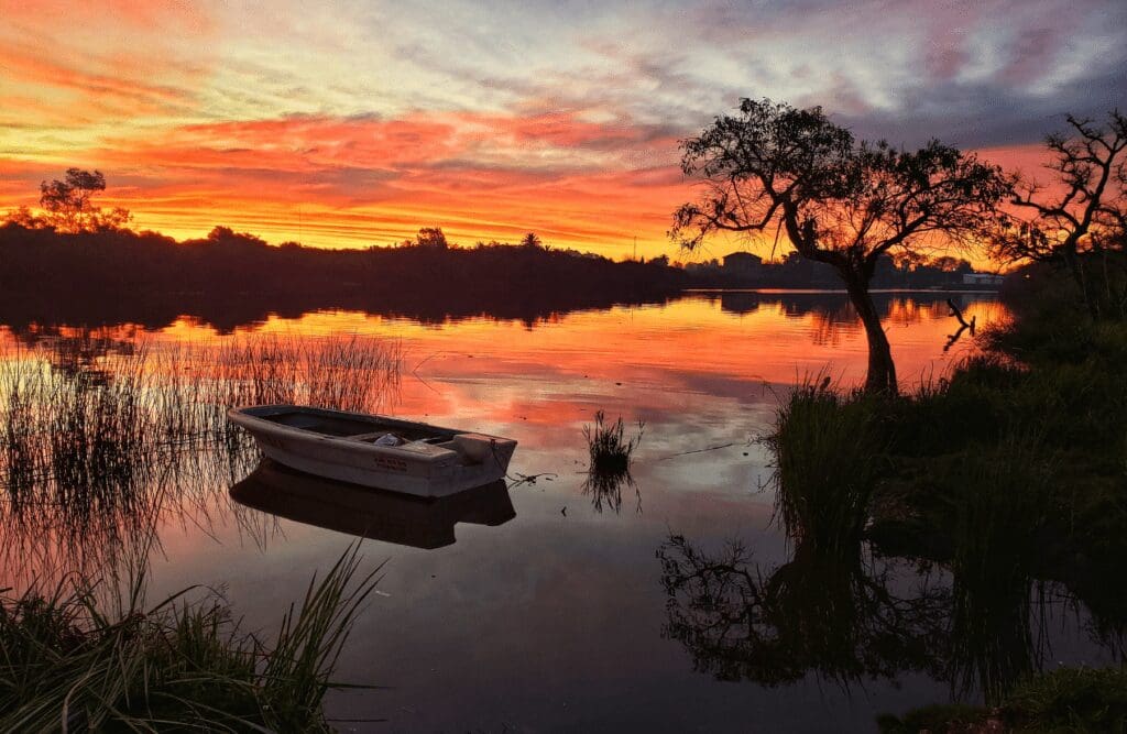 Scenic view of a lake and a small boat during sunset. Hypnotherapy for Alcoholism. Impact of Hypnosis on Sleep. Virtual Gastric Band Hypnosis Cost. Brisbane Livewell Clinic