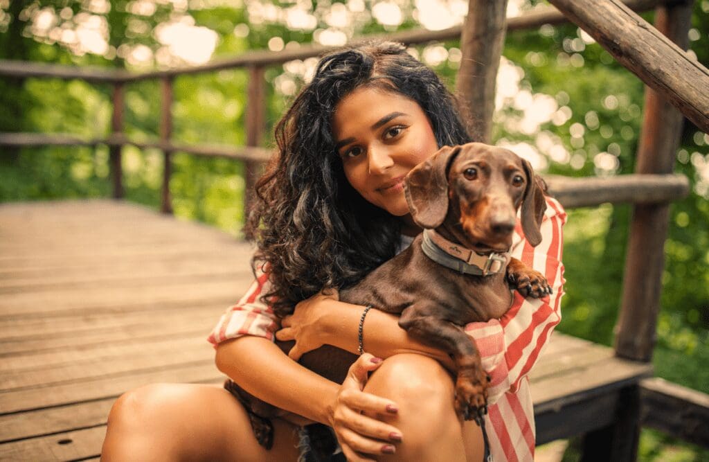 Woman hugging her dog while in nature. Natruopaths. Brisbane Livewell Clinic