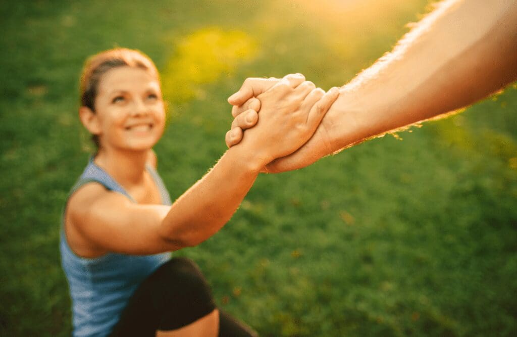 Person helping a the woman to stand up. Nutrition and Naturopathy. Brisbane Livewell Clinic