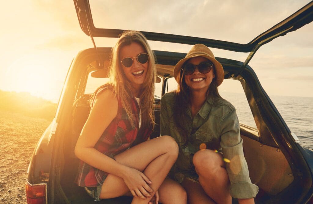 Two women sitting in the truck of a car. Clinical Hypnotherapy Tingalpa. Hypnotherapy for Smoking. Osteopath for Back Pain. Food Intolerance Testing Brisbane. Brisbane Livewell Clinic