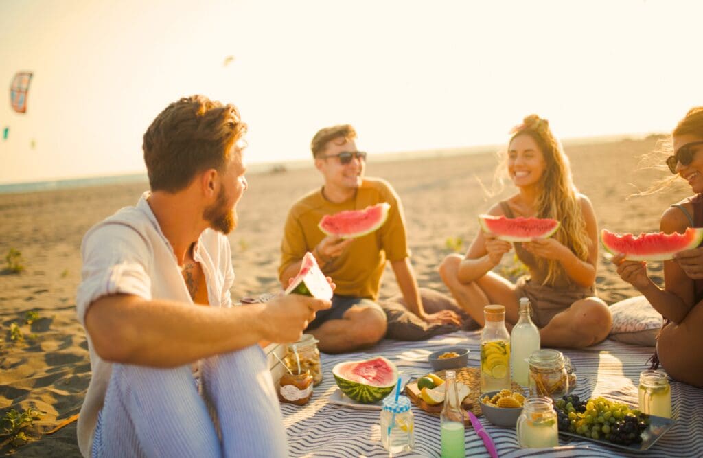 Friends having picnic on the beach. Overcoming Food Intolerance. Genetic Methylation Testing Brisbane. Clinical Nutritionist Cannon Hill. Brisbane Livewell Clinic