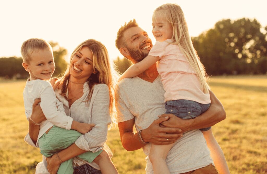 Parents carrying their children, sharing smiles and laughter. Hypnotherapy Near Me. Holistic Counselling Nundah. Brisbane Livewell Clinic