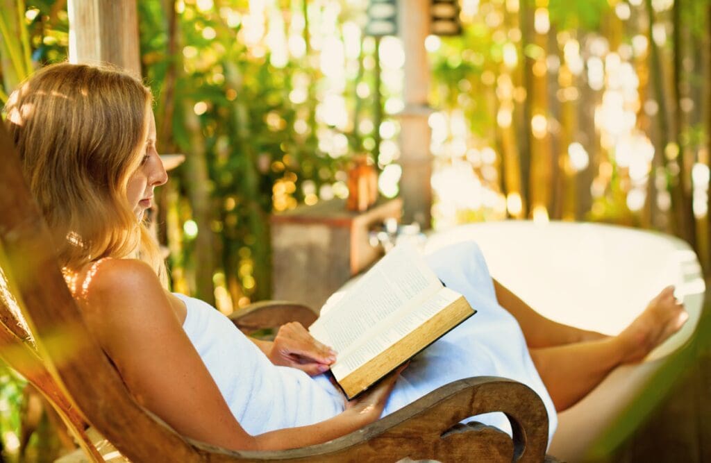 Woman reading a book. Hypnosis sleep. Detoxing. How Osteopathy may Support Posture and Structural Alignment. Brisbane Livewell Clinic