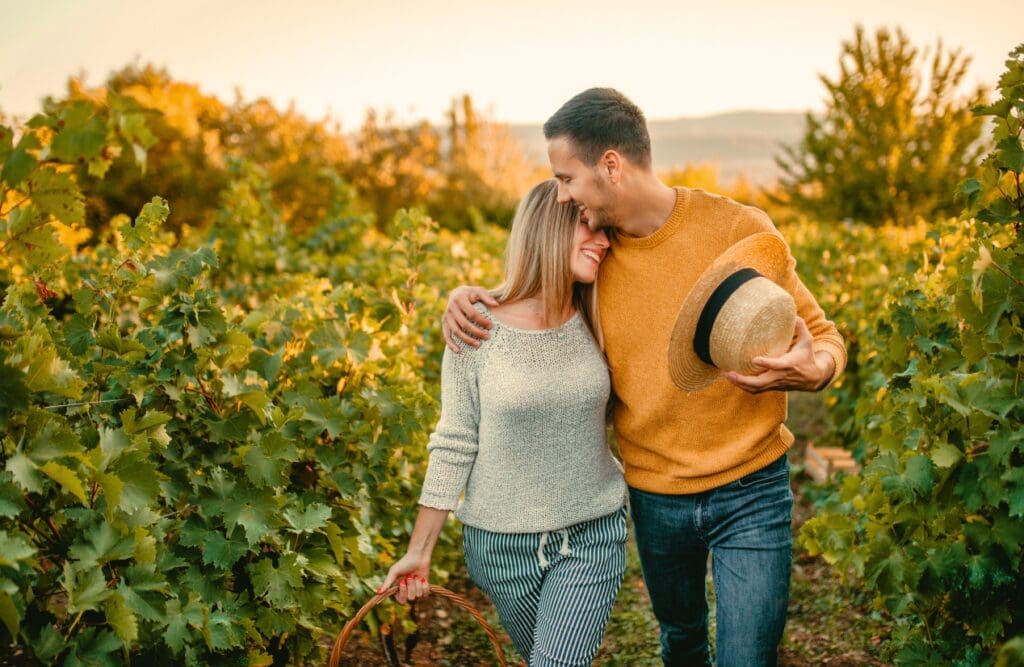 Happy couple walking through vineyard. Overcoming Food Intolerance. Brisbane Livewell Clinic