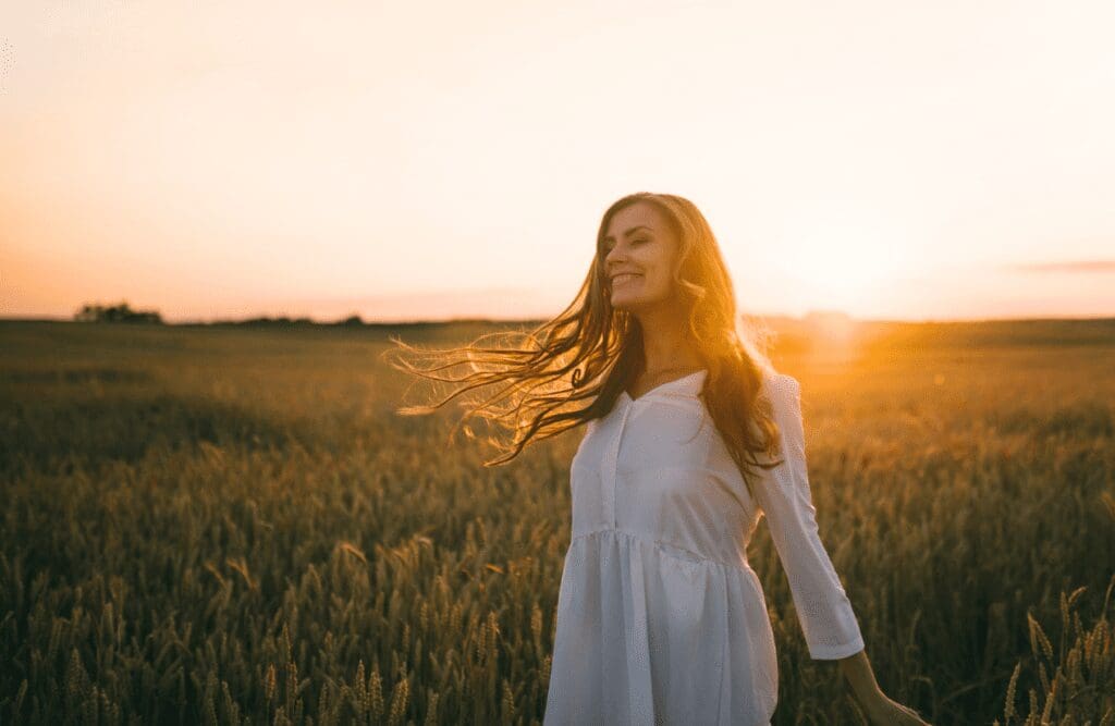 Woman standing in wheat field. Hypnosis in Sydney. Meaning of Hypnosis. Spiritually Disconnected Holistic Counselling. Brisbane Livewell Clinic