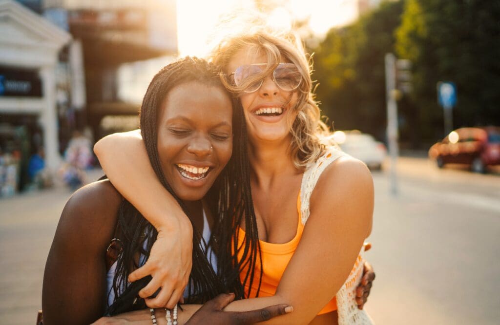 Two women having fun in the city.. Naturopaths Brisbane. Genetic Methylation Test Brisbane. Acupuncture for Migraines. Brisbane Livewell Clinic