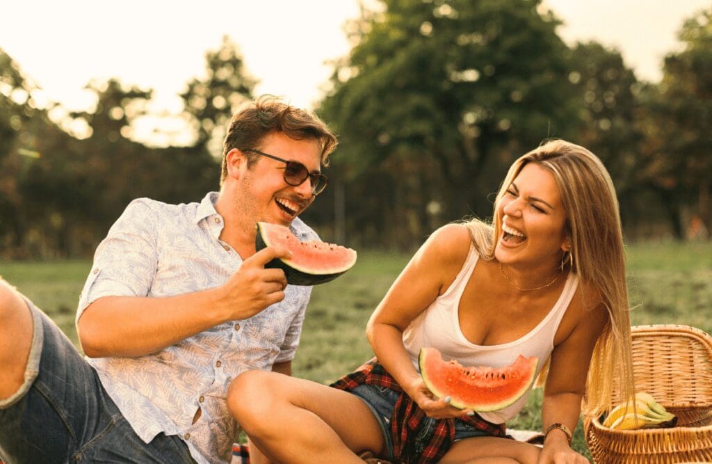 Couple on picnic eating watermelon. Nutrition Brisbane. Brisbane Livewell Clinic