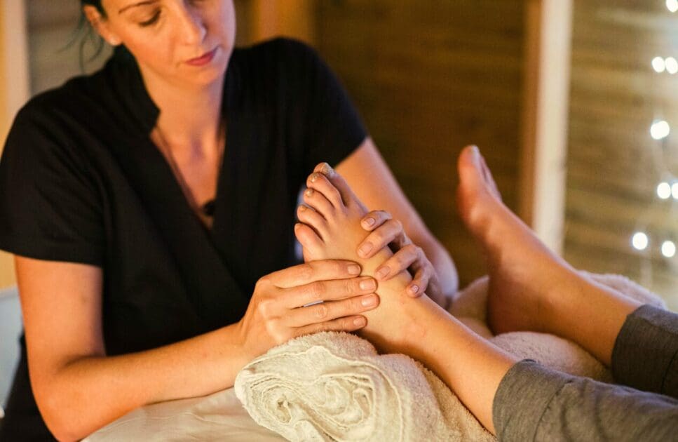 Masseur giving client a foot reflexology. Reflexology Near Me. Brisbane Livewell Clinic
