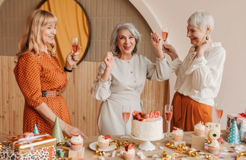 Three middle-aged women celebrating a birthday party. Menopause Clinic Near Me. Brisbane Livewell Clinic