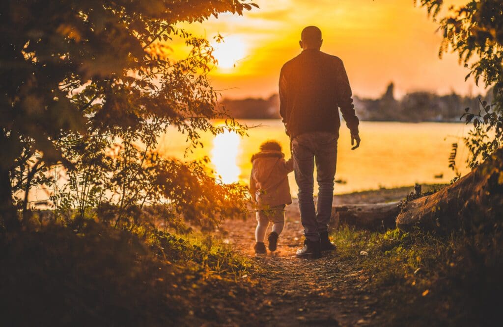 Father and son walking on the shore. Clinical Hypnotherapy Seven Hills. Brisbane Livewell Clinic. Naturopaths Brisbane.