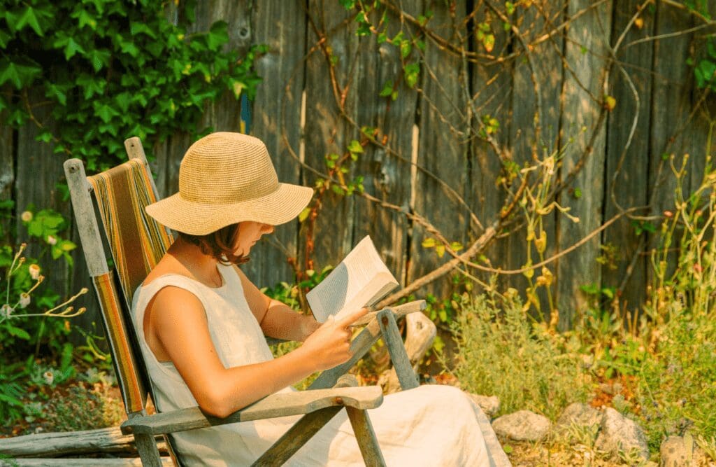Woman reading a book at the garden. Hypnotherapy Wavell Heights. Brisbane Livewell Clinic