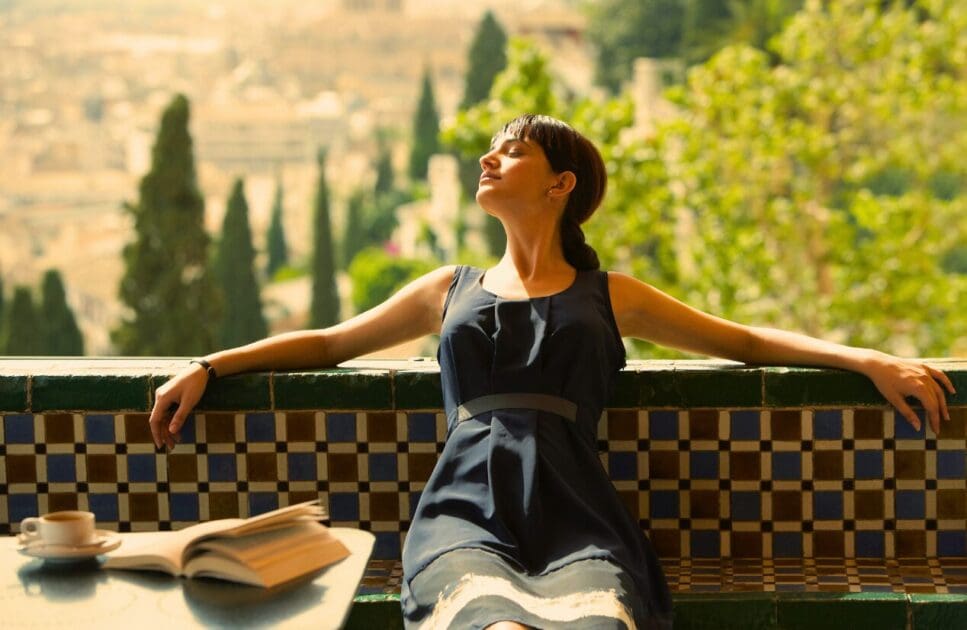 Woman relaxing on the balcony. Leaky Gut Syndrome. What is Clinical Hypnotherapy. What happens during Hypnotherapy. Osteopathy for Jaw Tension. Brisbane Livewell Clinic