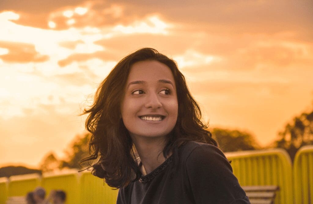 Woman smiling after a successful acupuncture session. Acupuncture Queensland. Hypnotherapy to Reduce Anxiety. Brisbane Livewell Clinic